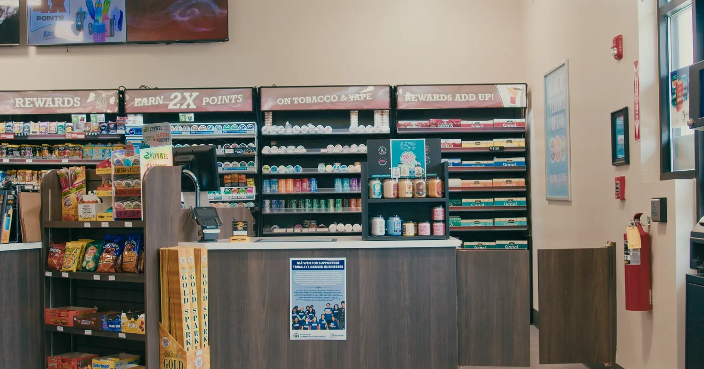The Smoker's Warehouse counter under the Rewards, Earn 2X Points, On Tobacco and Vape and Rewards Add Up signs